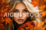 A beautiful woman head closeup in a autumn setup with some leaves mixed with the blond hair