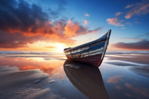 A small fishing boat stuck in the sand in a low tide dramatic sun set scenery 