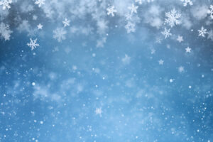 A christmas blue background with some snow flakes with large copy space